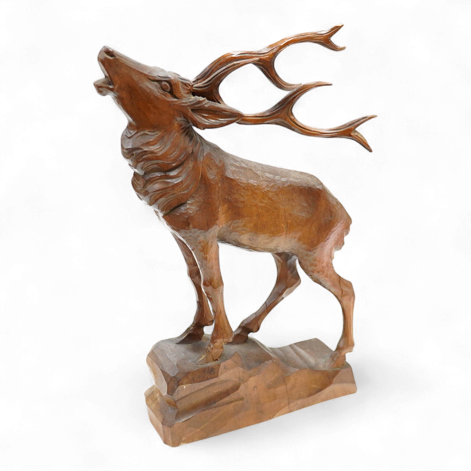 A Swiss Black Forest carving of a roaring stag, 34cm high